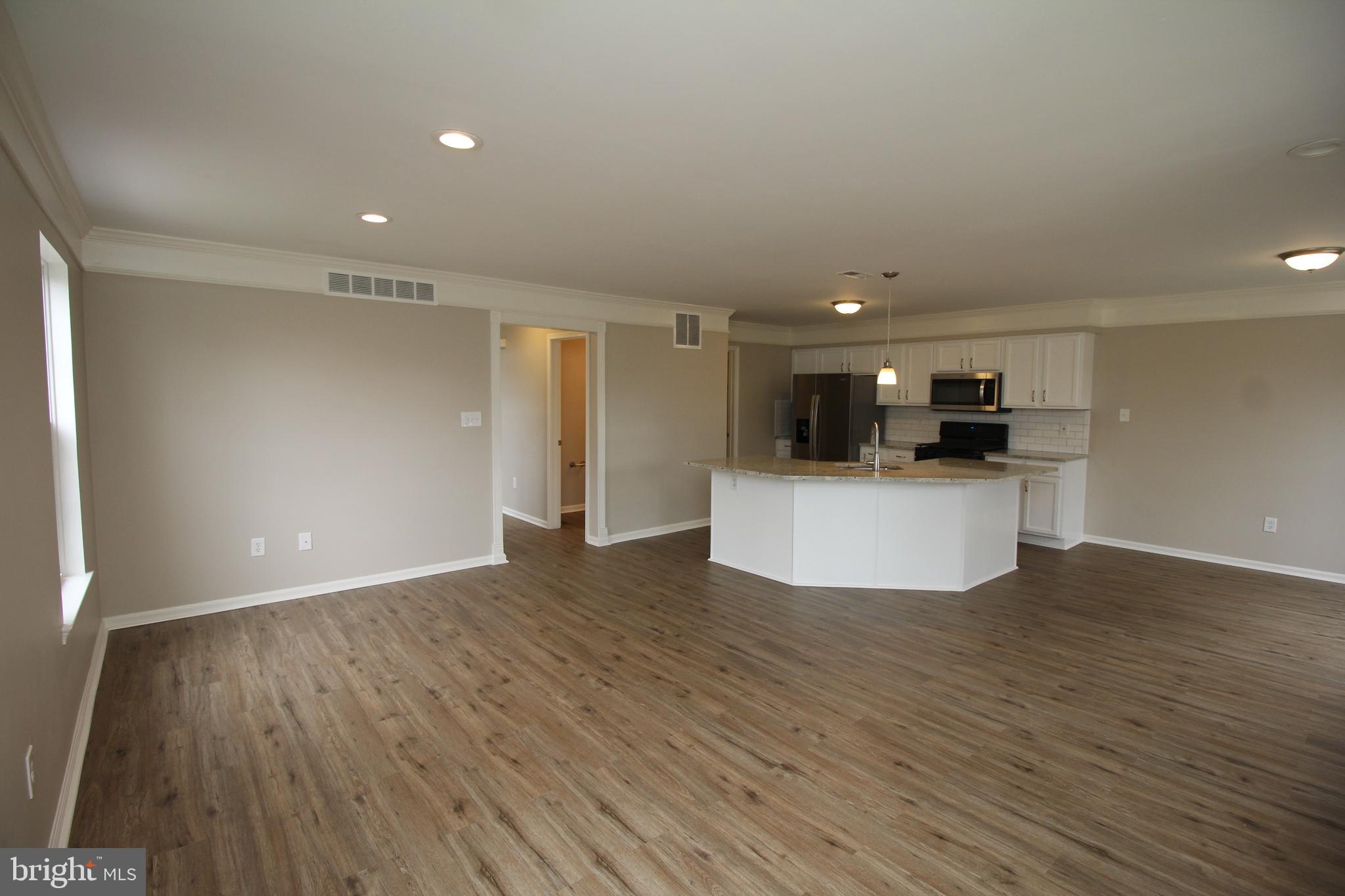 121 Wilson Lane Berlin, NJ 08009 - Photo 14 of 59 a view of kitchen with wooden floor and large window