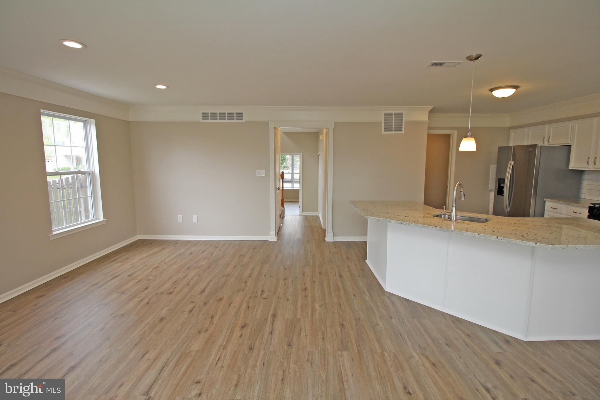 121 Wilson Lane Berlin, NJ 08009 - Photo 15 of 59 a view of a big room with wooden floor and windows