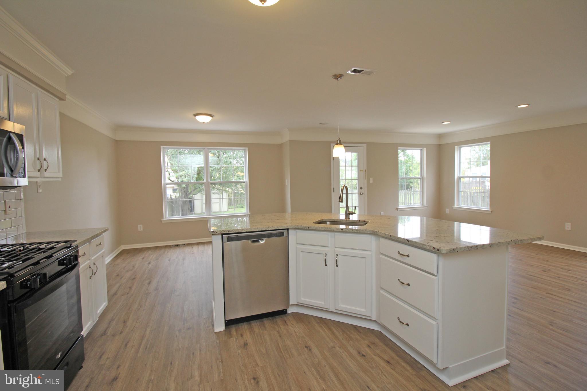 121 Wilson Lane Berlin, NJ 08009 - Photo 19 of 59 a kitchen with granite countertop a stove top oven sink and cabinets