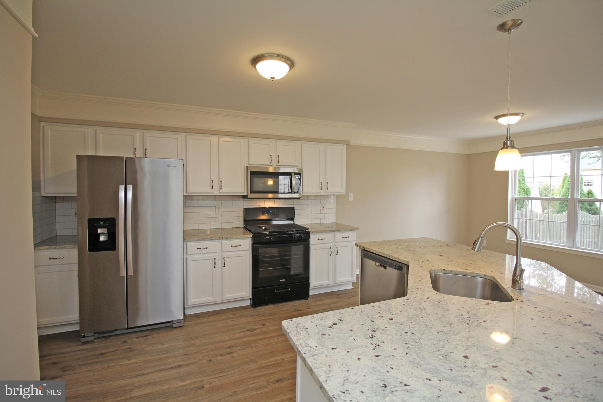 121 Wilson Lane Berlin, NJ 08009 - Photo 20 of 59 a kitchen with a refrigerator a stove top oven a sink and dishwasher