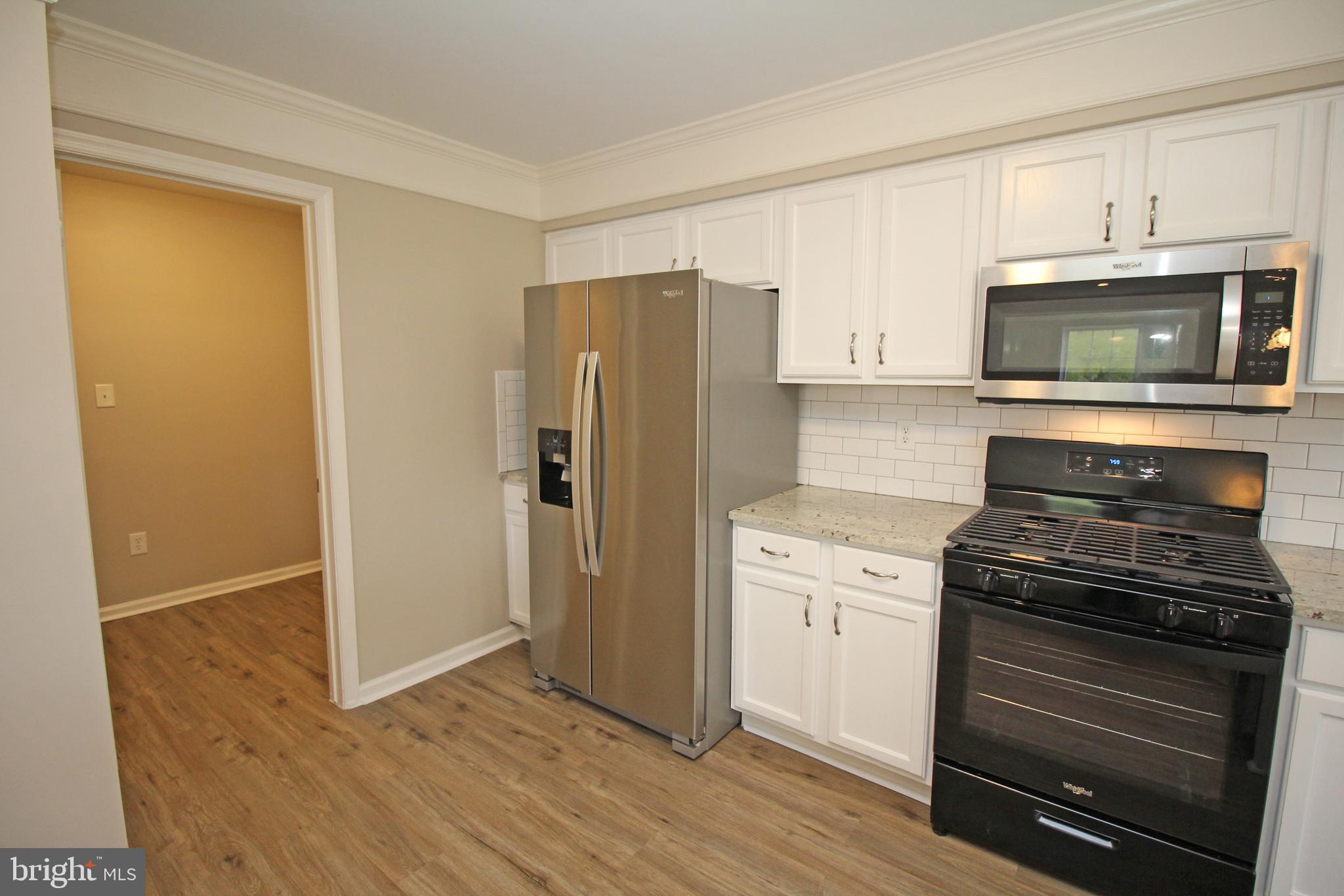 121 Wilson Lane Berlin, NJ 08009 - Photo 21 of 59 a kitchen with a refrigerator stove and microwave