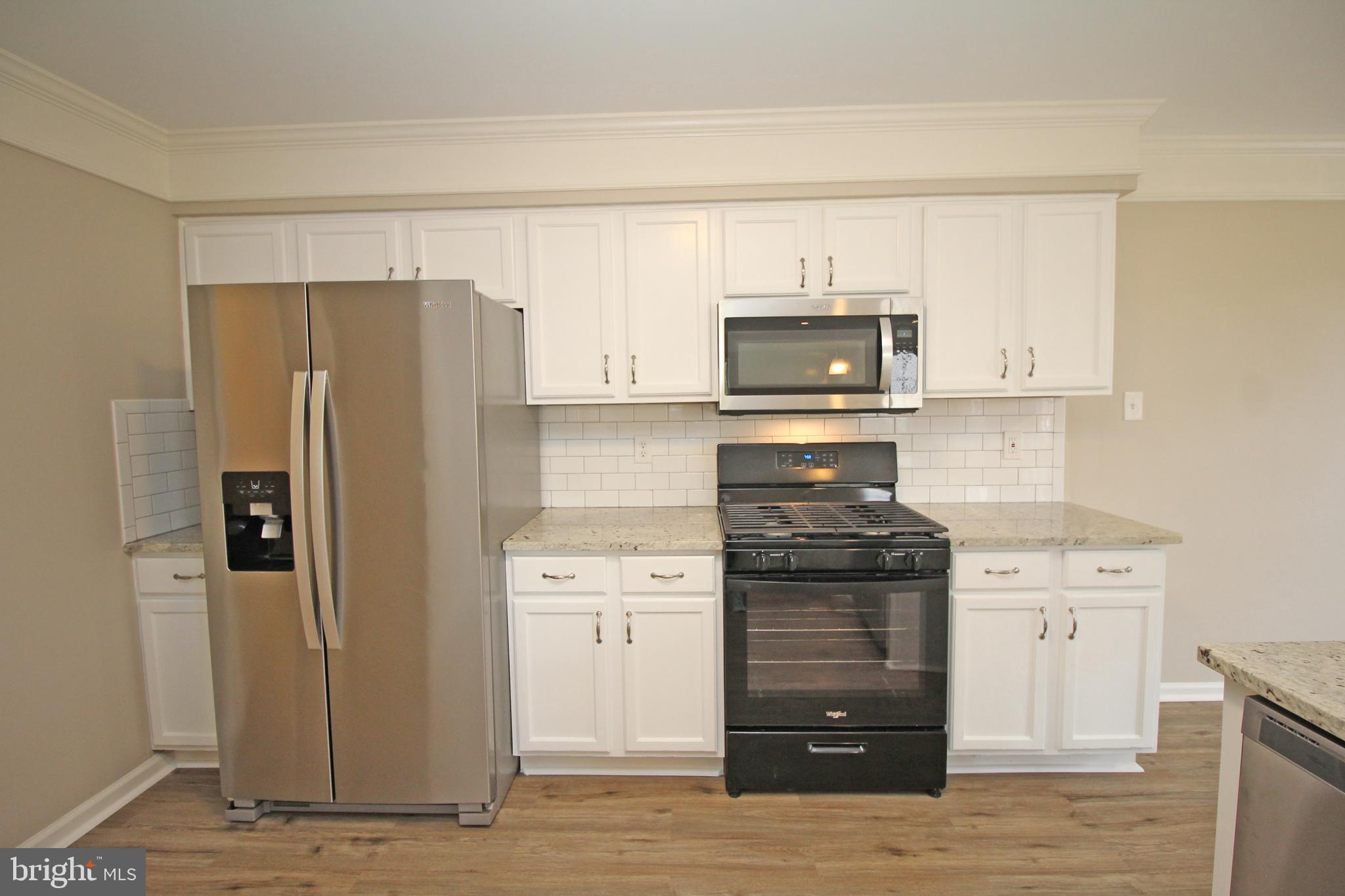 121 Wilson Lane Berlin, NJ 08009 - Photo 22 of 59 a kitchen with a stove and a refrigerator