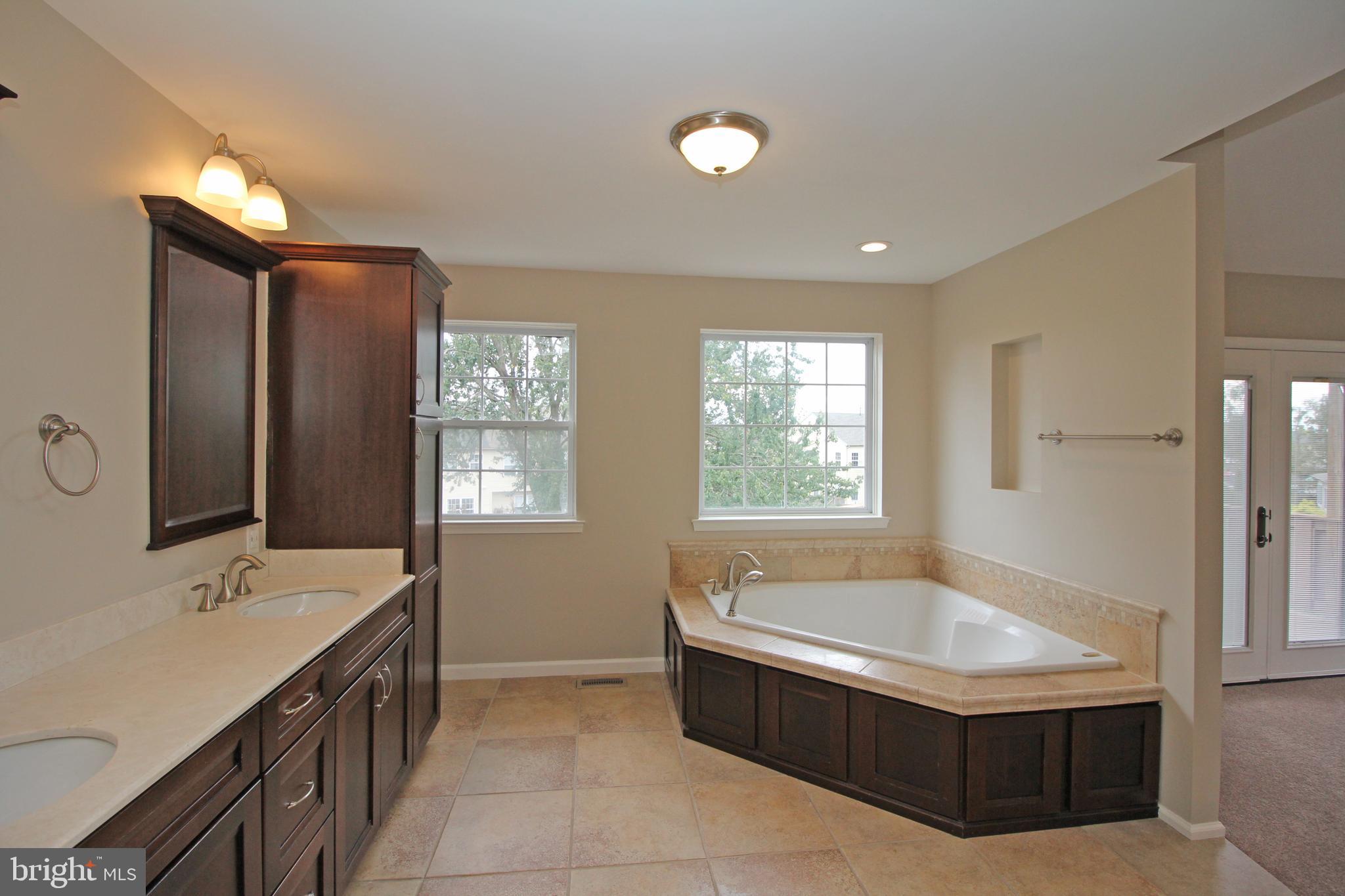 121 Wilson Lane Berlin, NJ 08009 - Photo 43 of 59 a spacious bathroom with a tub sink and mirror