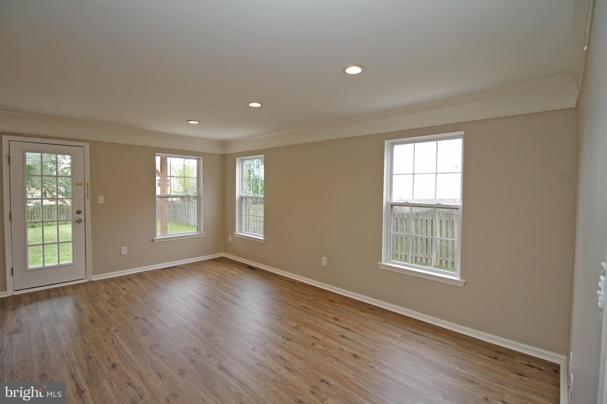 121 Wilson Lane Berlin, NJ 08009 - Photo 10 of 59 an empty room with wooden floor and windows