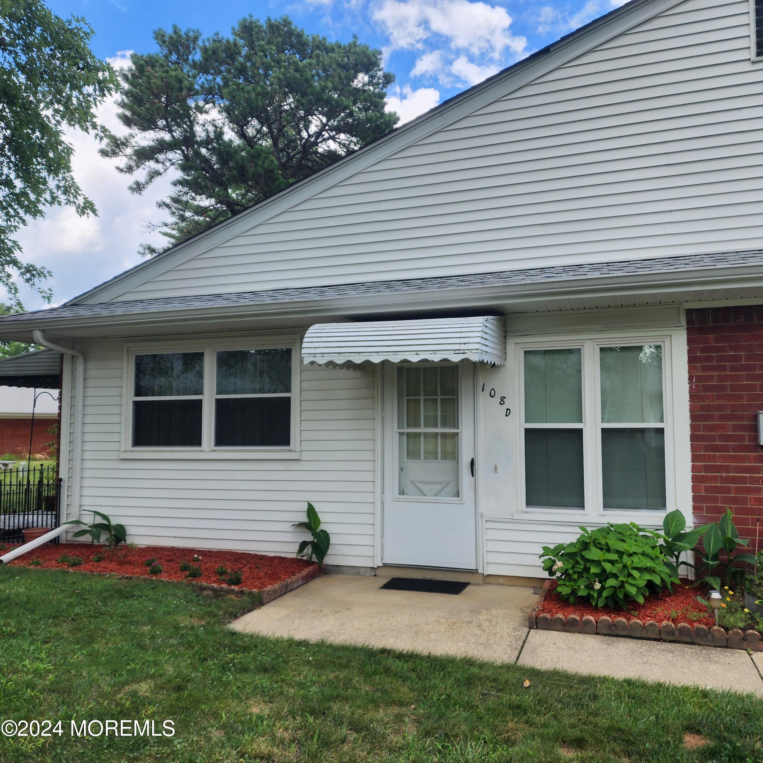 108 Hope Road, Unit D Whiting, NJ 08759 - Photo 1 of 26 a front view of a house with a yard and garage