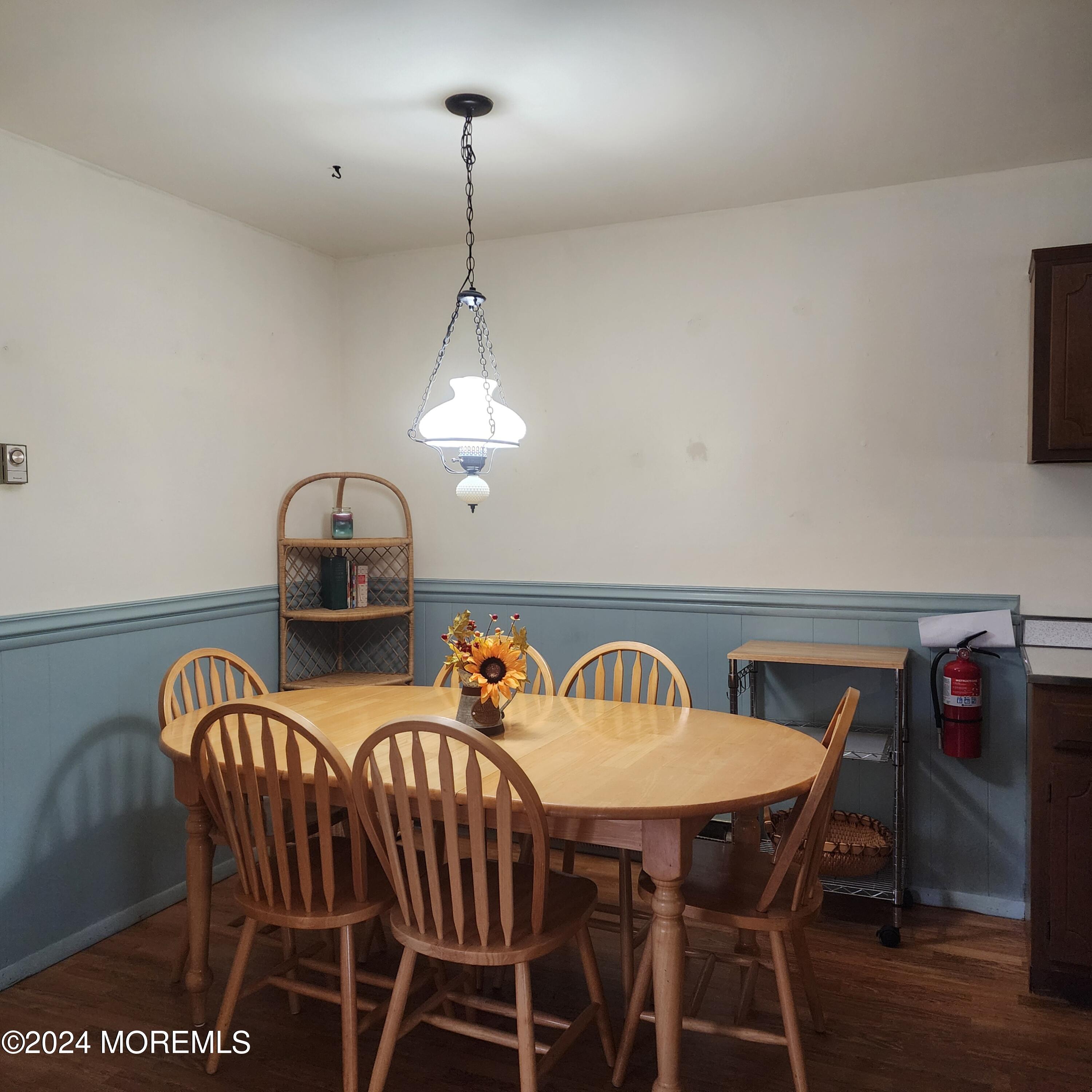 108 Hope Road, Unit D Whiting, NJ 08759 - Photo 13 of 26 a view of a dining room and livingroom with furniture wooden floor a chandelier