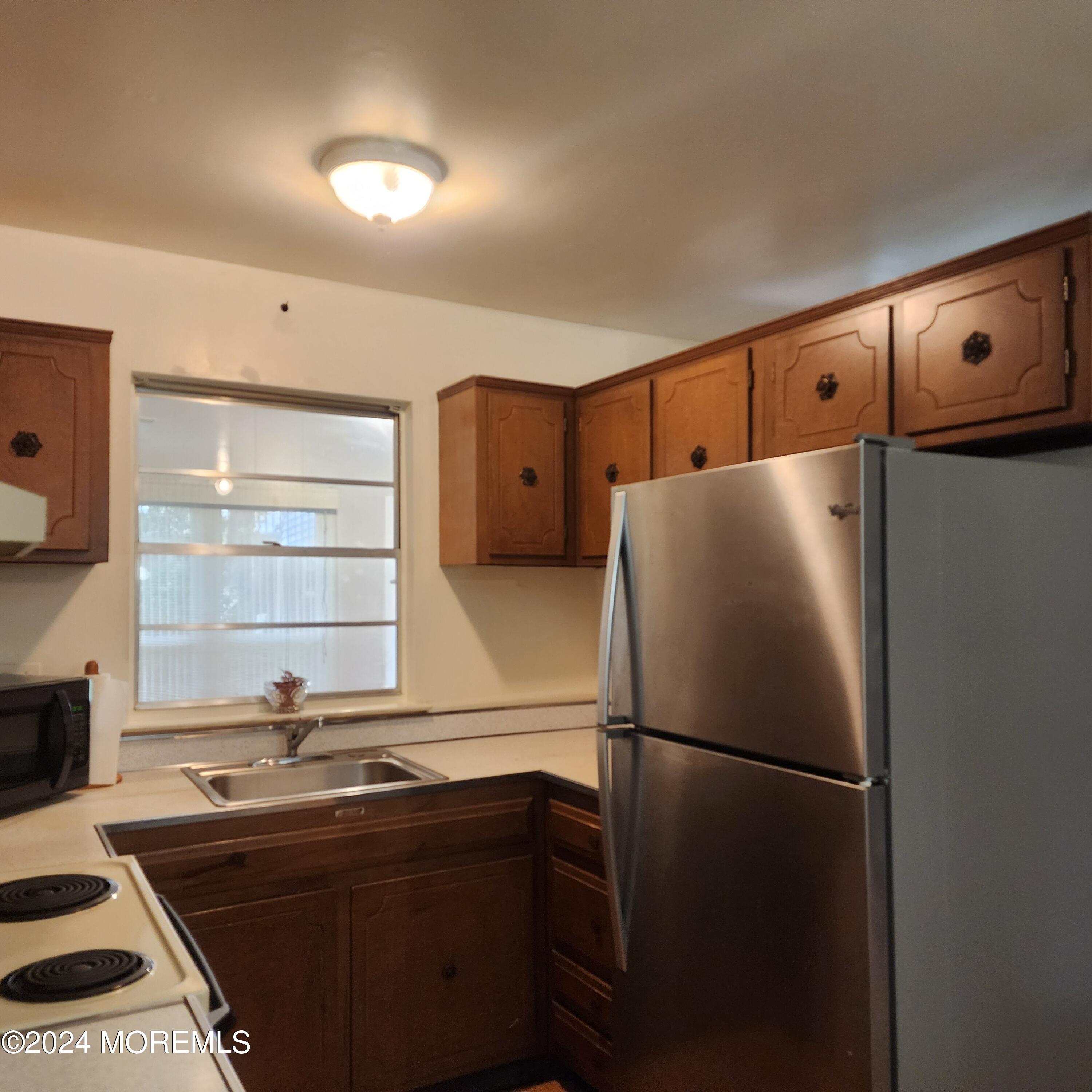 108 Hope Road, Unit D Whiting, NJ 08759 - Photo 14 of 26 a kitchen with stainless steel appliances a refrigerator and a stove