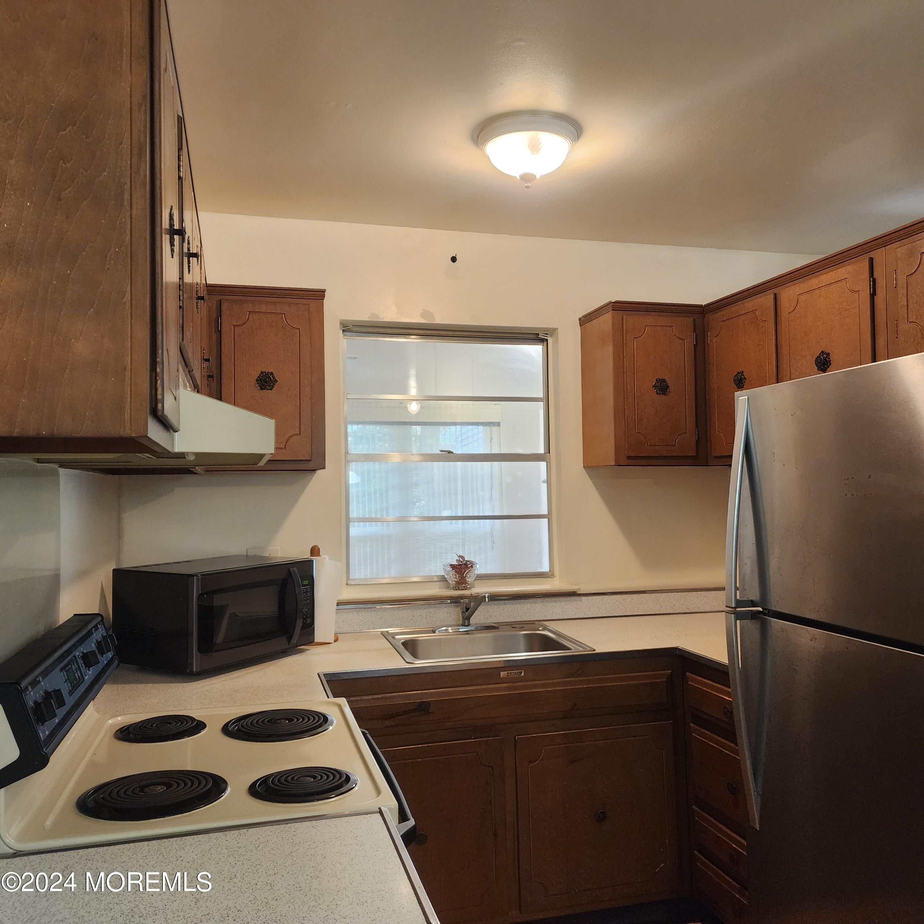 108 Hope Road, Unit D Whiting, NJ 08759 - Photo 15 of 26 a kitchen with stainless steel appliances a stove a refrigerator and a sink