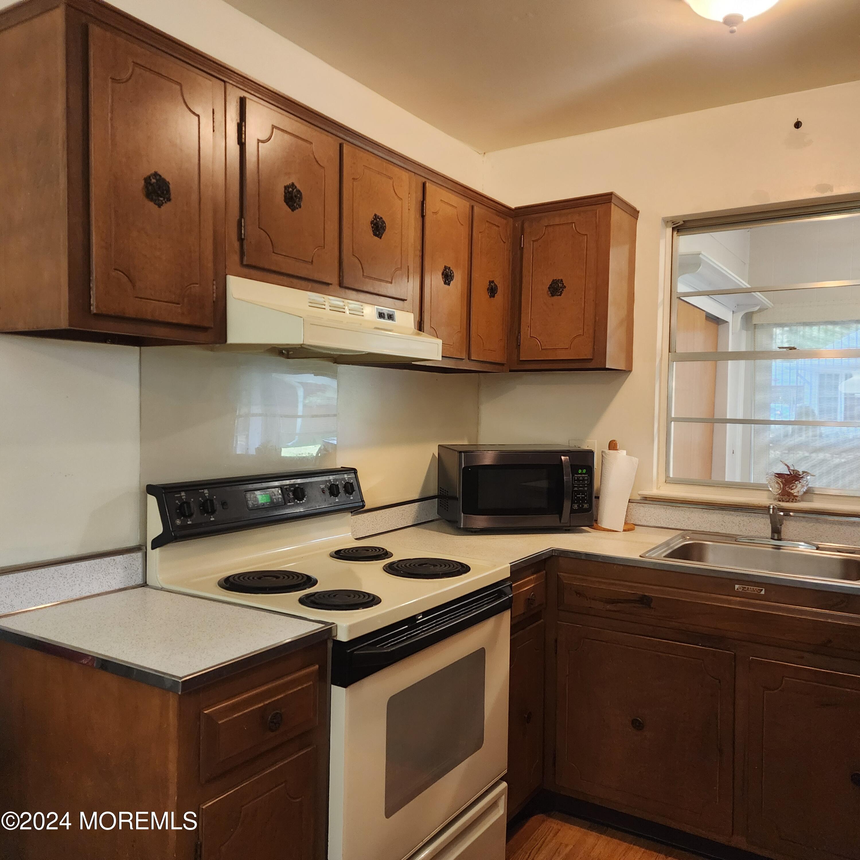 108 Hope Road, Unit D Whiting, NJ 08759 - Photo 16 of 26 a kitchen with stainless steel appliances a stove a sink and a microwave