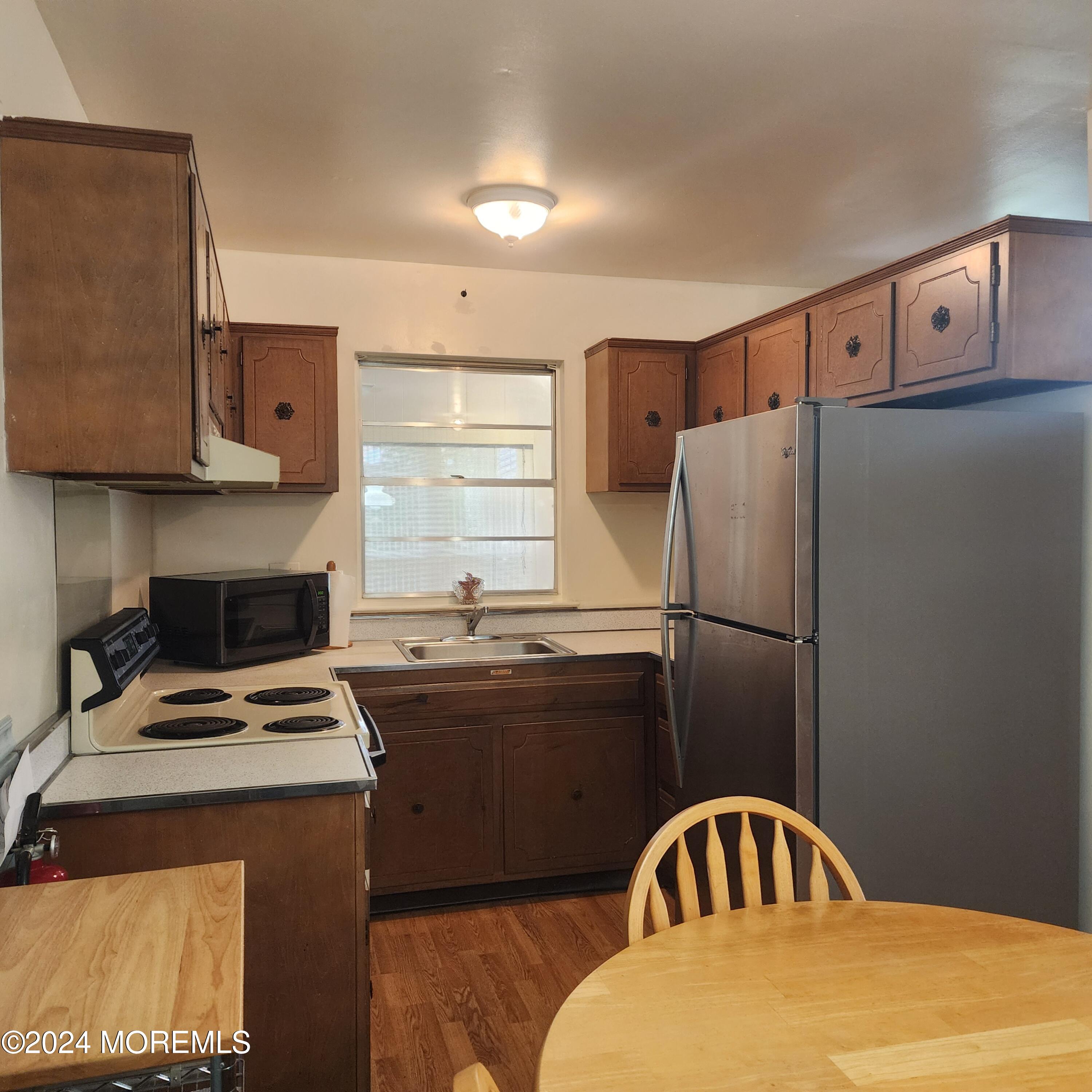 108 Hope Road, Unit D Whiting, NJ 08759 - Photo 17 of 26 a kitchen with a refrigerator and a stove top oven