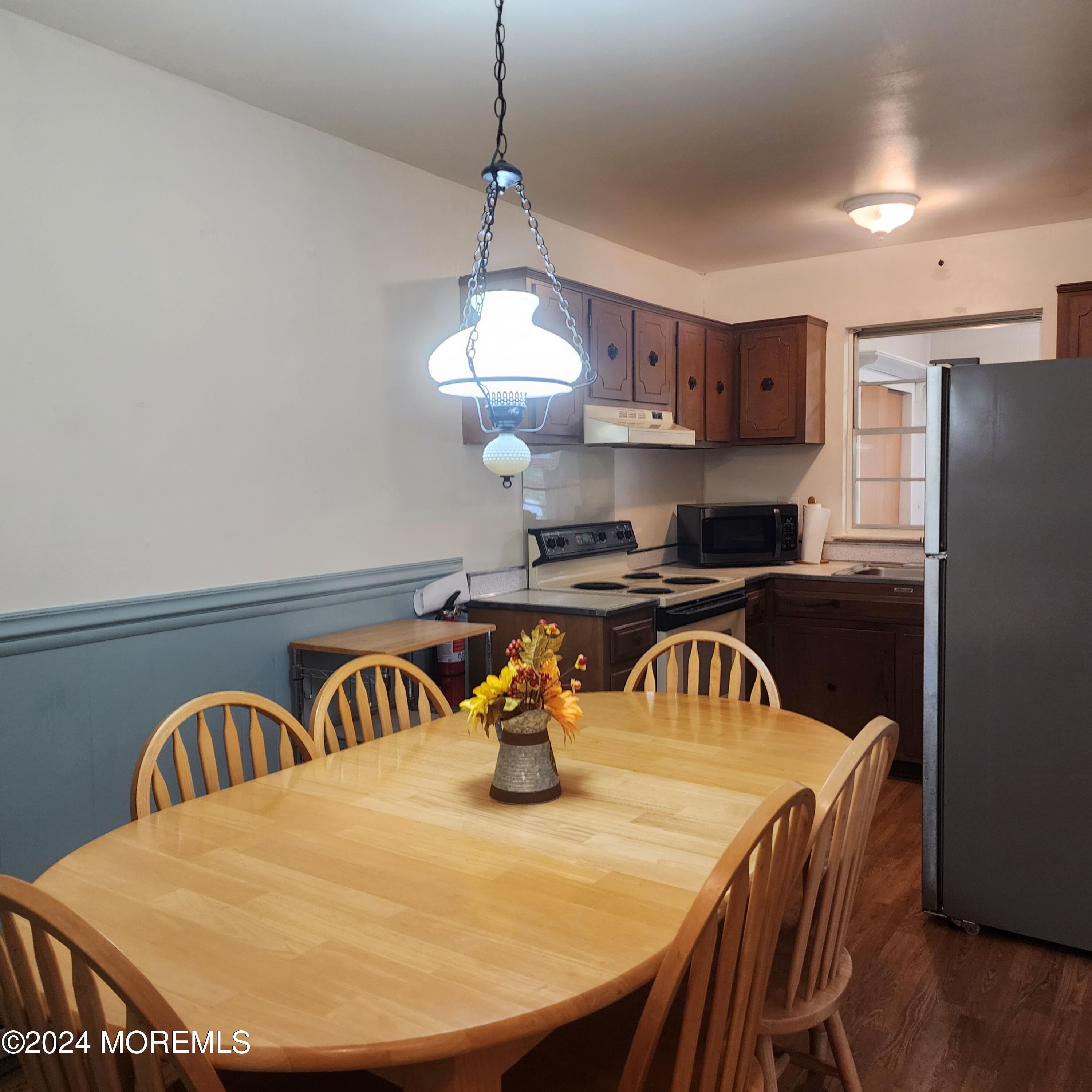 108 Hope Road, Unit D Whiting, NJ 08759 - Photo 19 of 26 a kitchen with stainless steel appliances granite countertop a sink a stove a dining table and chairs