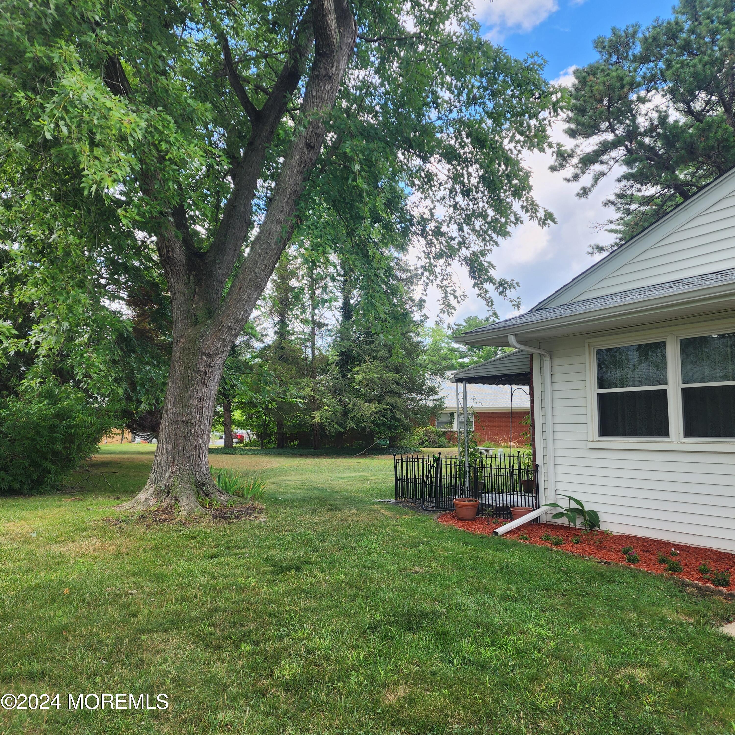 108 Hope Road, Unit D Whiting, NJ 08759 - Photo 3 of 26 a view of backyard with deck and garden