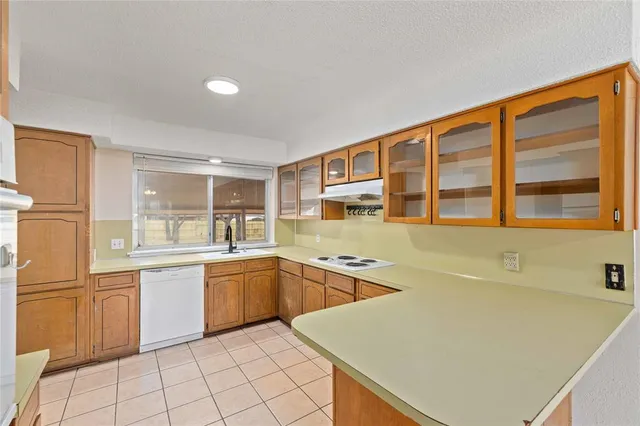 a kitchen with a stove a sink and a refrigerator