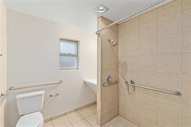 a bathroom with a toilet and a shower