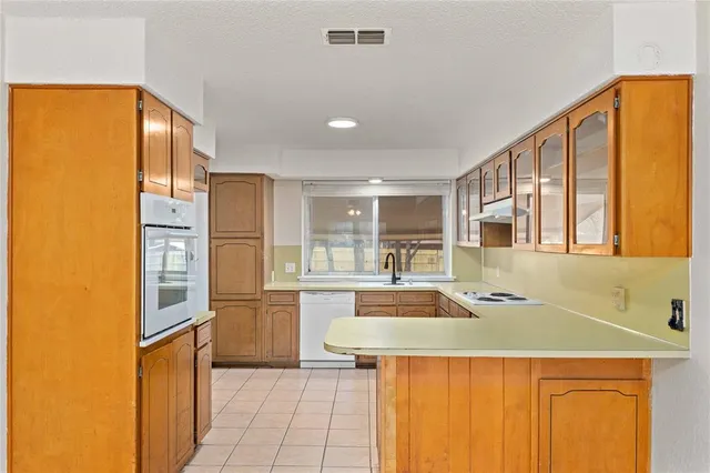 a kitchen with stainless steel appliances granite countertop a sink and refrigerator
