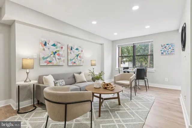a living room with furniture and a floor to ceiling window