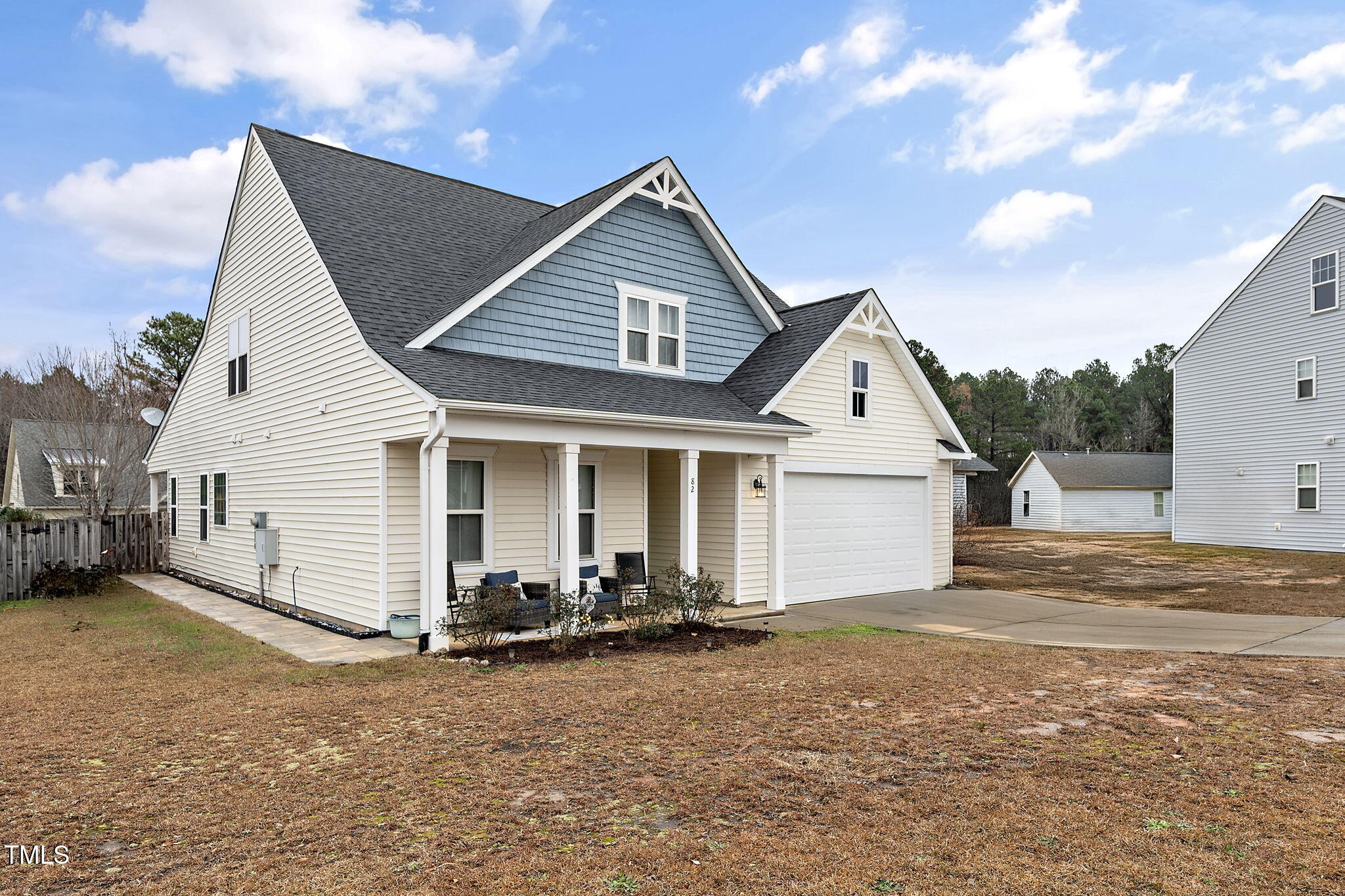 a view of a house with backyard and a tree