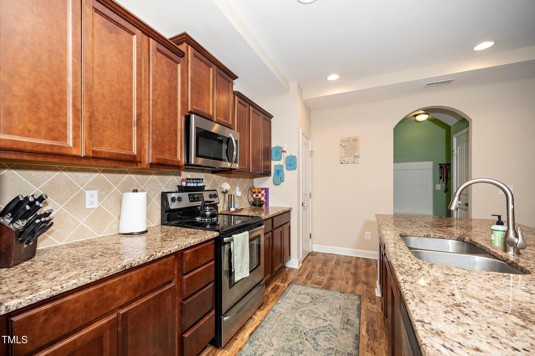 82 Mariners Point Way Garner, NC 27529 - Photo 11 of 30 a kitchen with granite countertop a stove a sink and a granite counter tops