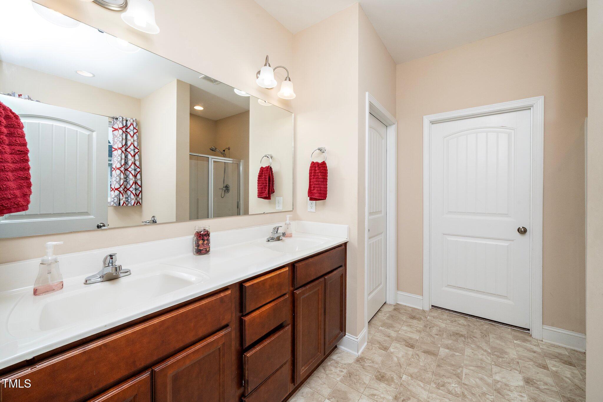 82 Mariners Point Way Garner, NC 27529 - Photo 20 of 30 a bathroom with a double vanity sink mirror and
