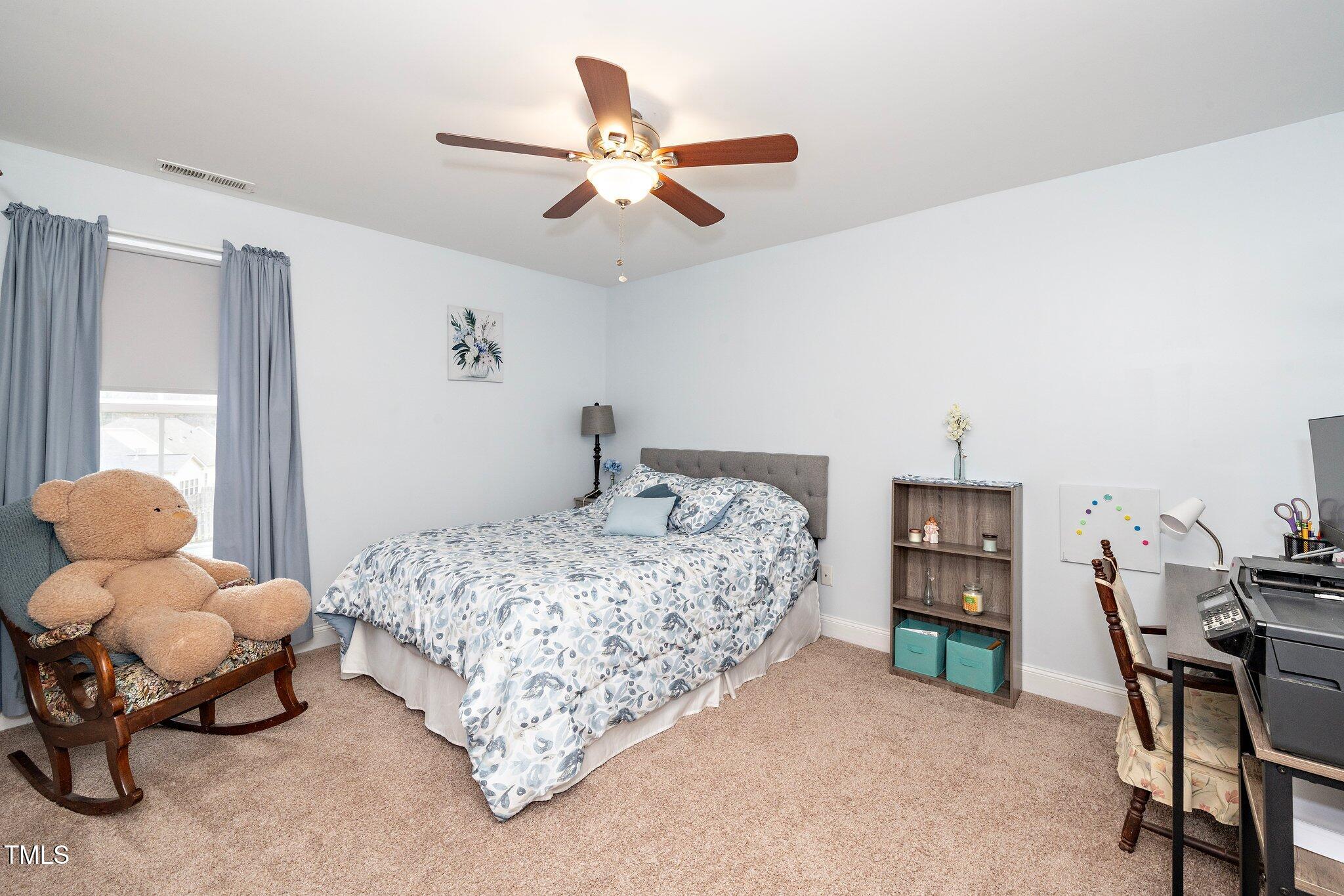 82 Mariners Point Way Garner, NC 27529 - Photo 22 of 30 a bedroom with a bed and a chandelier