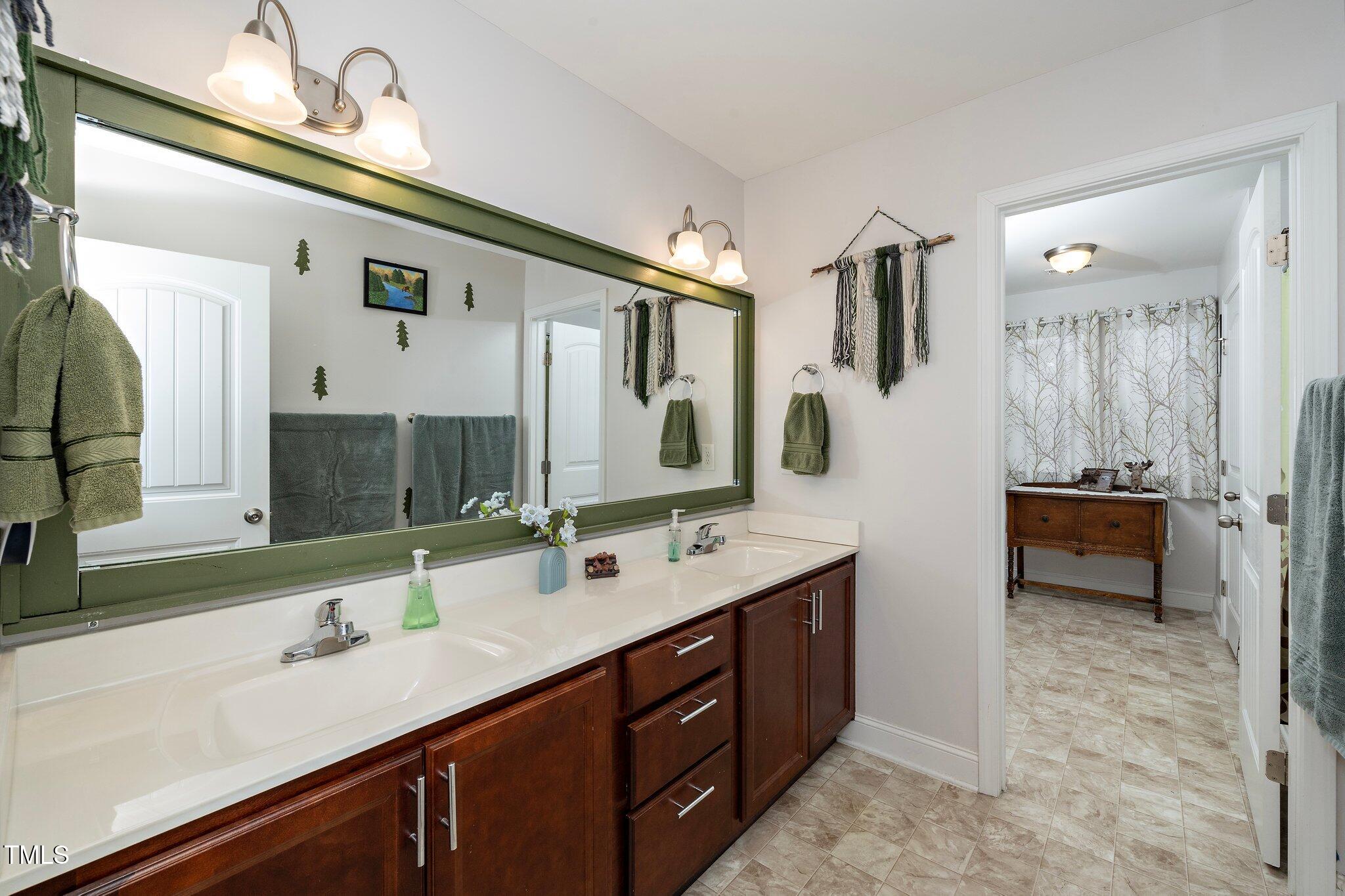 82 Mariners Point Way Garner, NC 27529 - Photo 23 of 30 a spacious bathroom with a double vanity sink a mirror and a shower