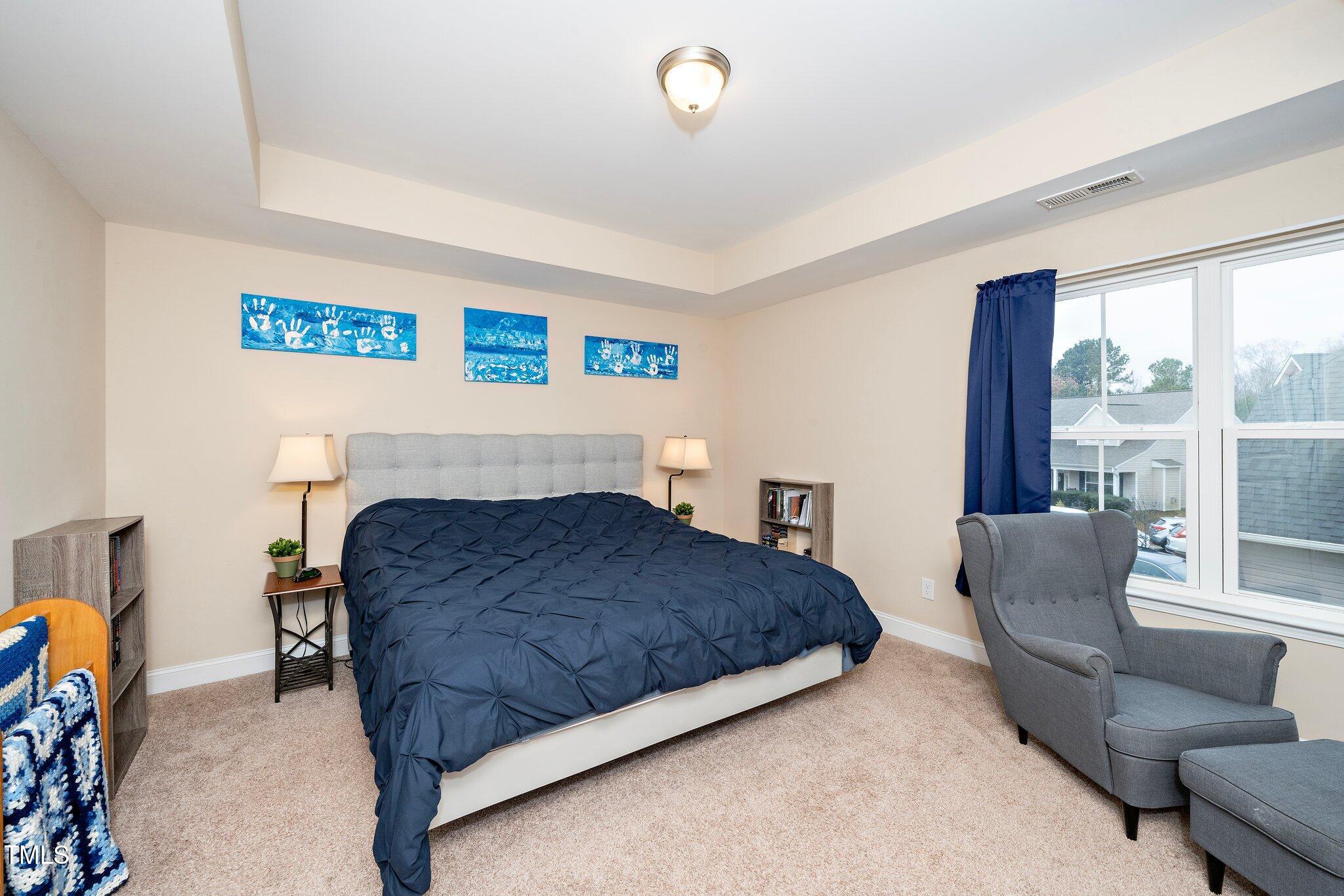 82 Mariners Point Way Garner, NC 27529 - Photo 24 of 30 a bedroom with a bed and a couch
