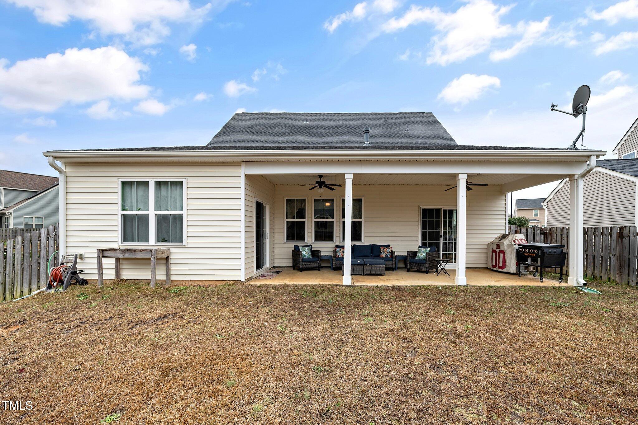82 Mariners Point Way Garner, NC 27529 - Photo 28 of 30 a front view of a house with outdoor seating and a patio