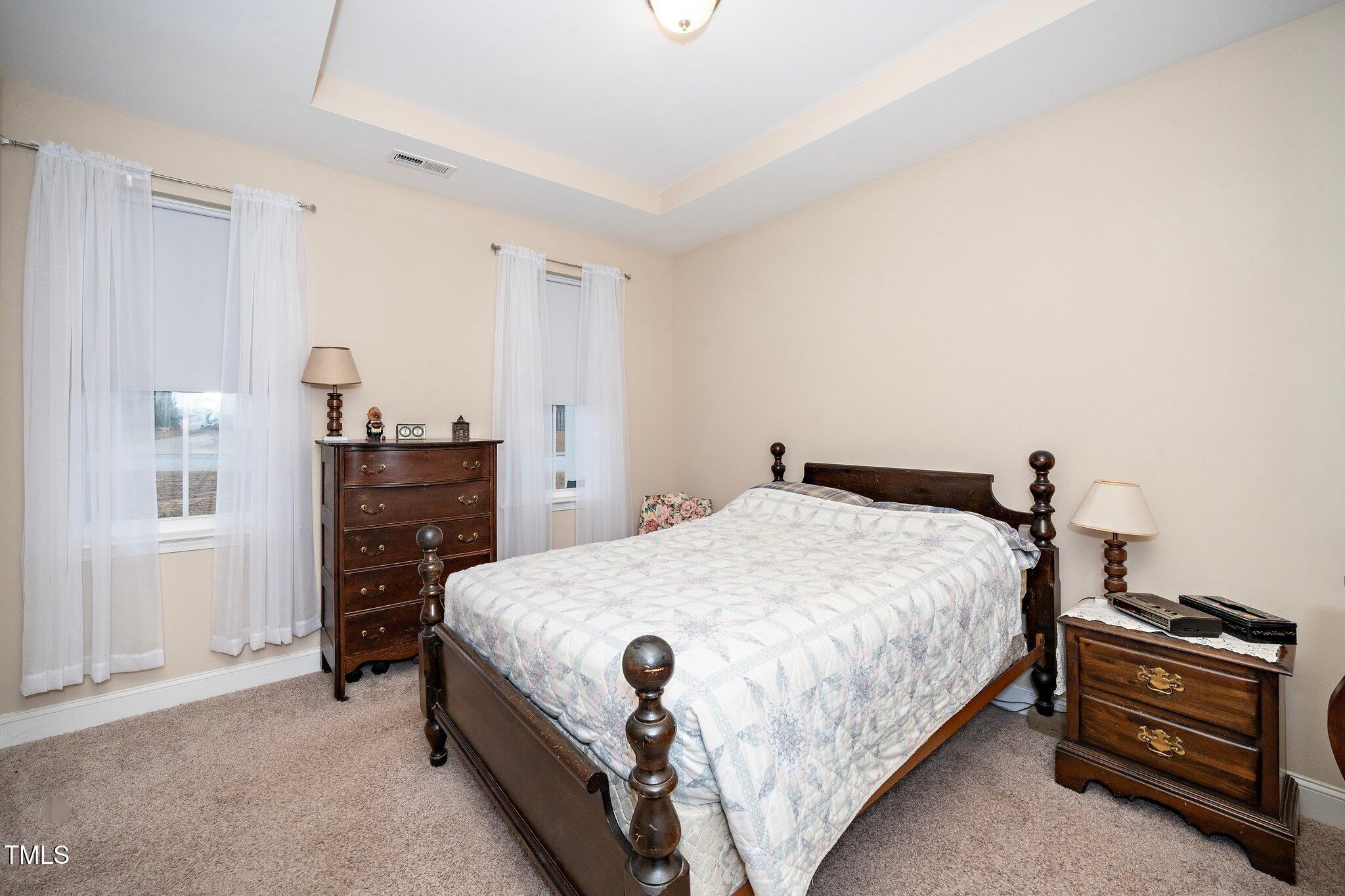 82 Mariners Point Way Garner, NC 27529 - Photo 5 of 30 a bedroom with a bed and dresser