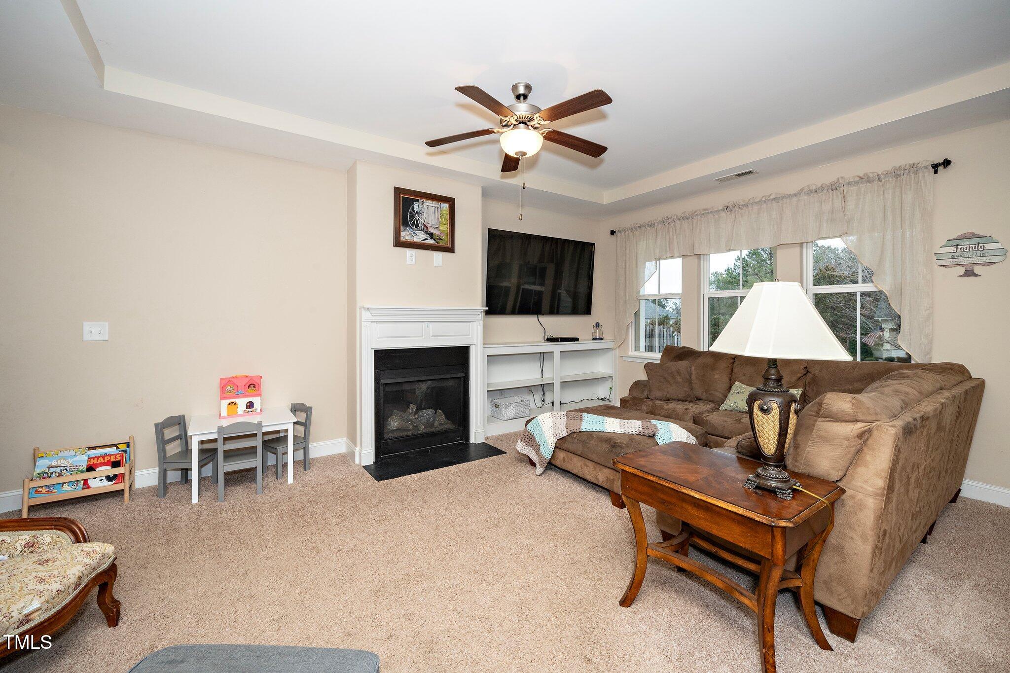 82 Mariners Point Way Garner, NC 27529 - Photo 8 of 30 a living room with furniture and a fireplace