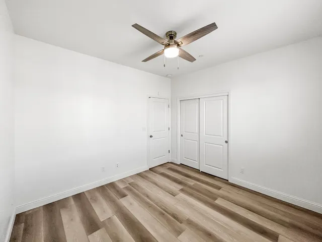 a bathroom with a granite countertop sink a light fixture and a mirror