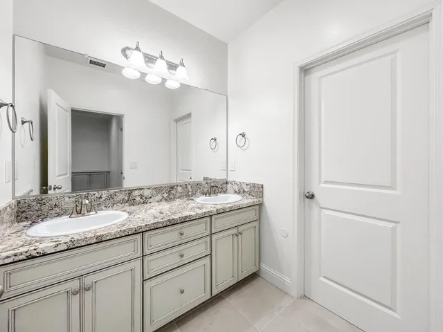 an empty room with a window and a ceiling fan