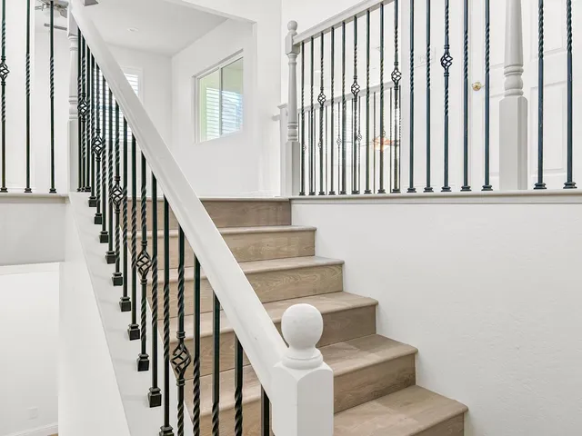 an empty room with a window and ceiling fan
