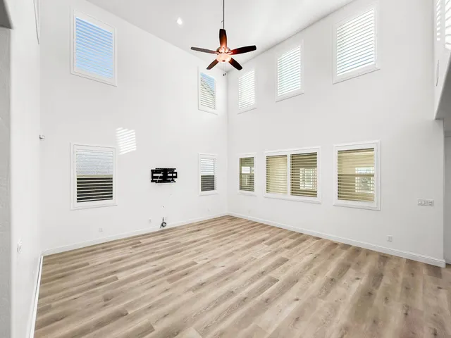a view of a livingroom with kitchen appliances and furniture