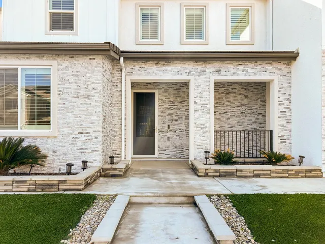 a front view of a house with a yard