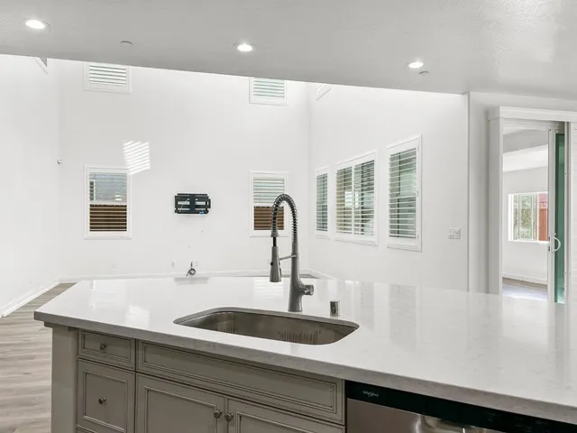 a kitchen with sink a faucet and cabinets