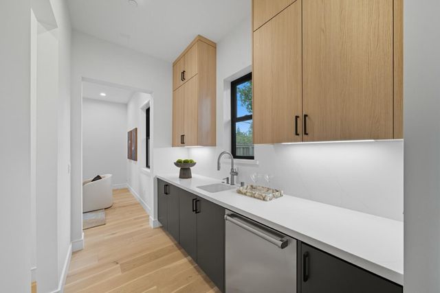 a dining room with kitchen island stainless steel appliances furniture and a window