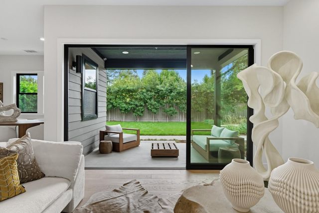 a bedroom with furniture and a large window