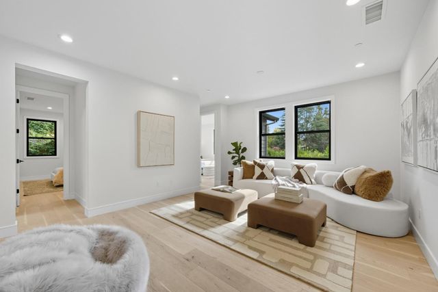 a bedroom with furniture and a wooden floor