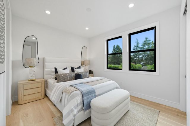 a bedroom with a bed and glass door