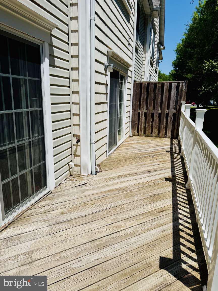 629 Ruxton Road, Unit 74 Solomons, MD 20629 - Photo 10 of 24 a view of a balcony with wooden floor and fence