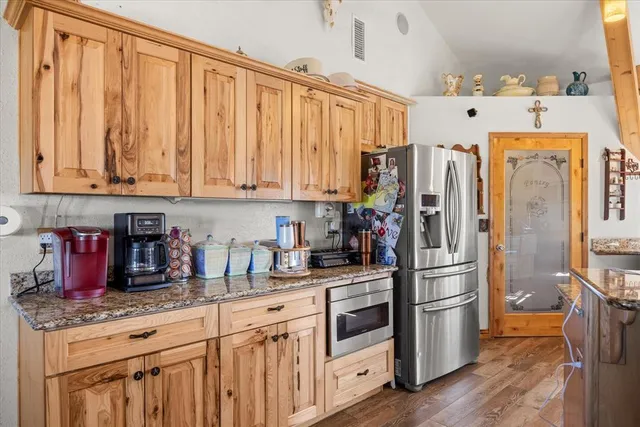 a kitchen with stainless steel appliances granite countertop a refrigerator sink and cabinets