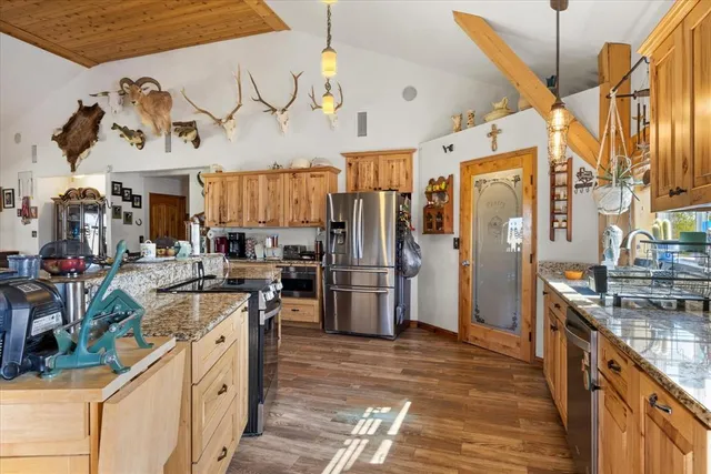 a kitchen with lots of counter top space and stainless steel appliances