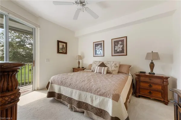 a spacious bedroom with a bed and a chandelier