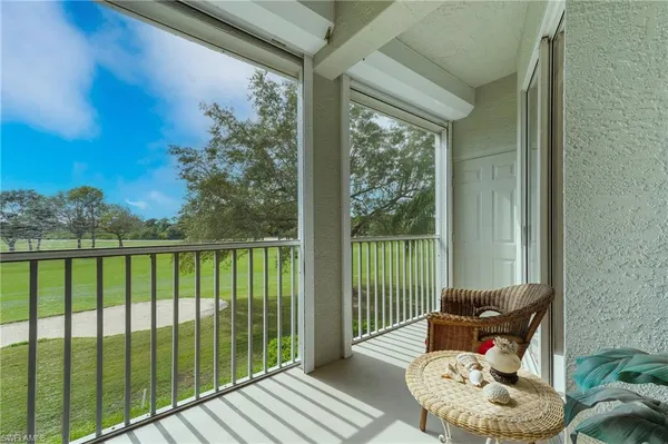 a view of a balcony with chair and glass door