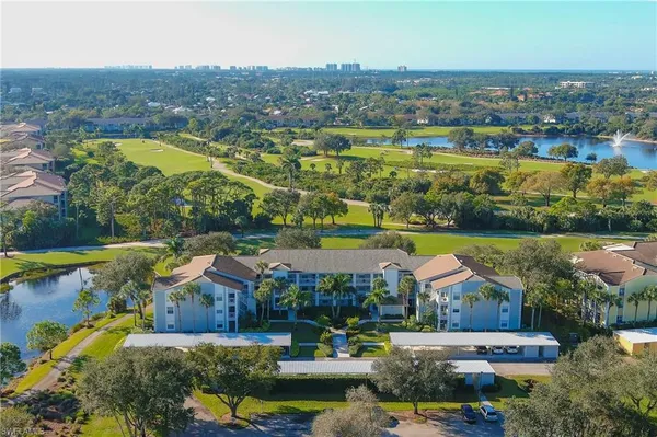 an aerial view of residential houses with outdoor space and swimming pool