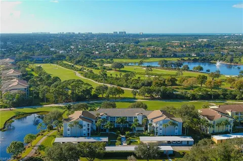 an aerial view of residential houses with outdoor space and river