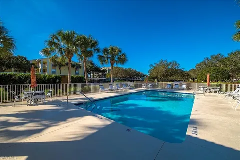a view of a swimming pool with an outdoor space and seating area