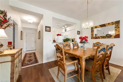 a view of a dining room with furniture and chandelier