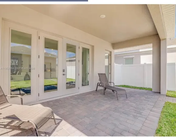 a living room with furniture and large windows