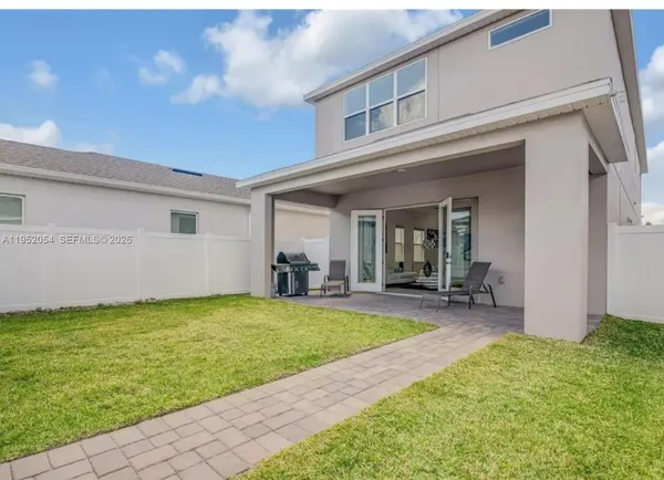 a view of a house with swimming pool and a yard
